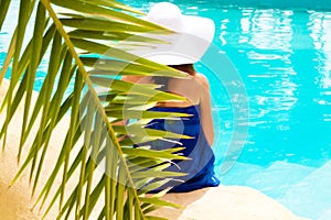 Girl sitting by the pool