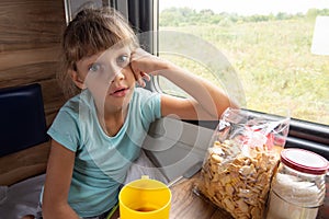 Girl sitting in a reserved seat carriage in a train funny looks in the frame