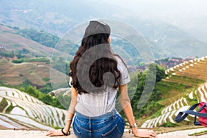 Girl sitting at rice terrace viewpoint