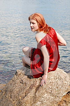 Girl sitting on the rock