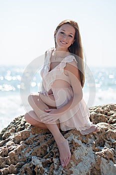 Girl sitting on a rock