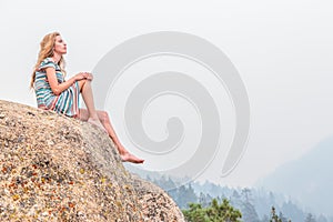 Girl sitting on rock