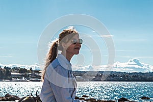 Girl Sitting on a Rock at Kitsilano Beach in Vancouver, Canada