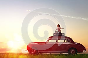 Girl sitting on roof of car.