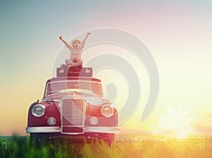 Girl sitting on roof of car.