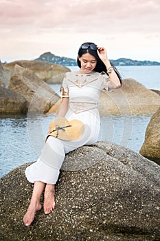 Girl sitting on the seaside rocks