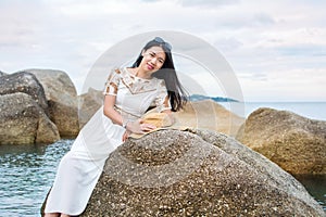 Girl sitting on the seaside rocks