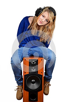The girl sitting on the speaker