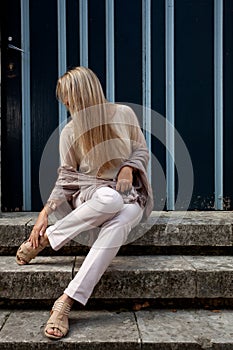 Girl sitting stairs medieval Romanesque door