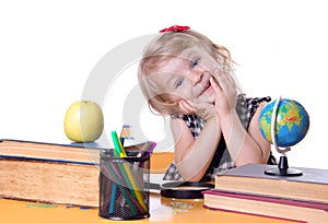 Girl sitting at table with books and globe