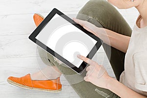 Girl sitting with tablet in hands.Top view.Mock up.Copy space.Template.Blank. photo