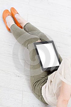 Girl sitting with tablet in hands.Top view.Mock up.Copy space.Template.Blank. photo