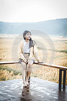 Girl sitting on the terrace in an autumn morning