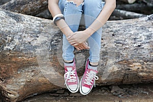 Girl Sitting on the timber.