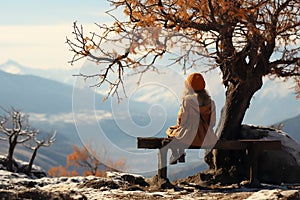 The Girl on sitting and tree silhouette in mountains. Christmas celebration and winter holiday