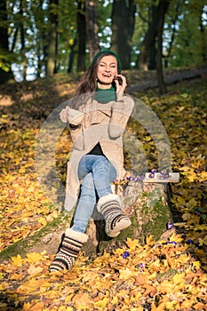 Girl sitting on tree stump