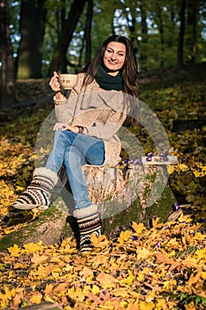 Girl sitting on tree stump