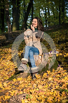 Girl sitting on tree stump