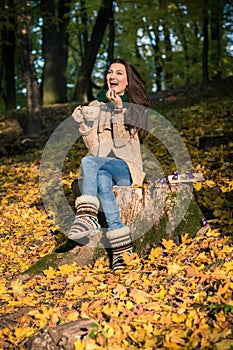 Girl sitting on tree stump