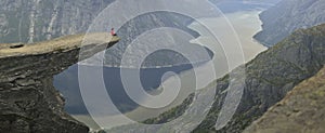 Girl sitting on Trolltunga in Norway