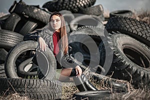 Girl sitting in the tyres