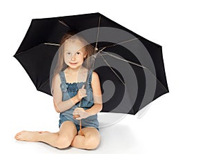 Girl sitting under an umbrella
