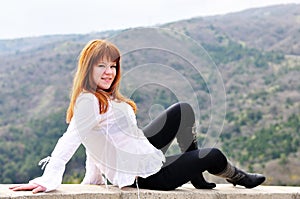 Girl sitting on the wall photo