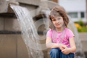 Girl sitting by waterfall