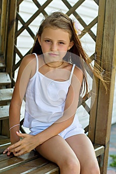 Girl sitting on a wooden bench