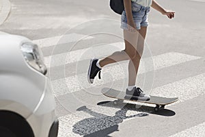 Girl on skateboard on pedestrian crossing