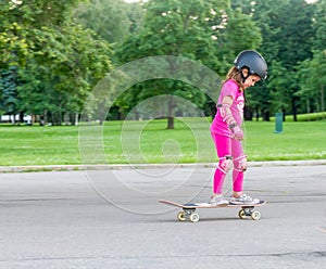 Girl skateboarding on natural background