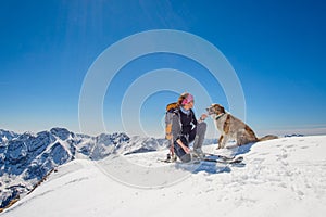 Girl ski touring with his dog