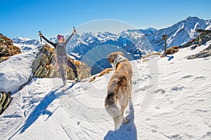 Girl ski touring in the mountains with dog