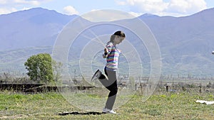 Girl skipping rope on a meadow