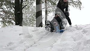 Girl sledding down the hill