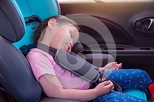 Girl sleeping on carseat in car photo