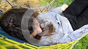 Girl sleeping in hammock and swinging