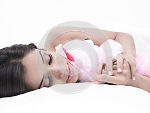 Girl sleeping with her teddy bear