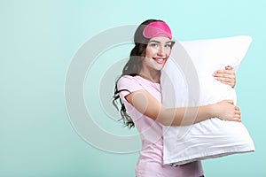 Girl with sleeping mask and white pillow