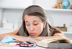 Girl is sleeping after studying