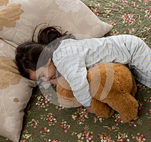 Girl sleeping with teddy bear