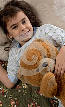 Girl sleeping with teddy bear