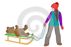 Little cute girl carries a teddy bear on sled in winter. Active leisure outdoors in winter