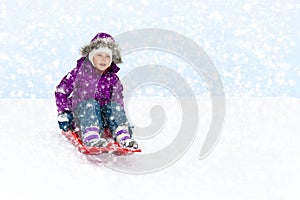 Girl Sliding in Snow