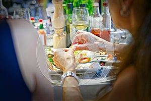 Girl slips with his hands a crustacean of his shrimp dish