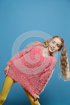 Girl small tilted her head  on  background.  half-length portrait.