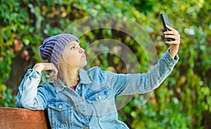 Girl with smartphone green nature background. Woman having mobile conversation. Mobile communication and social networks