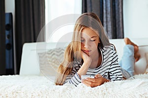 Girl with smartphone on sofa