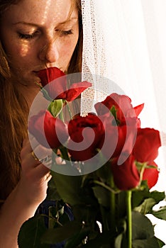 Girl smelling red roses