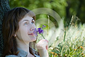 Girl smells a flowers